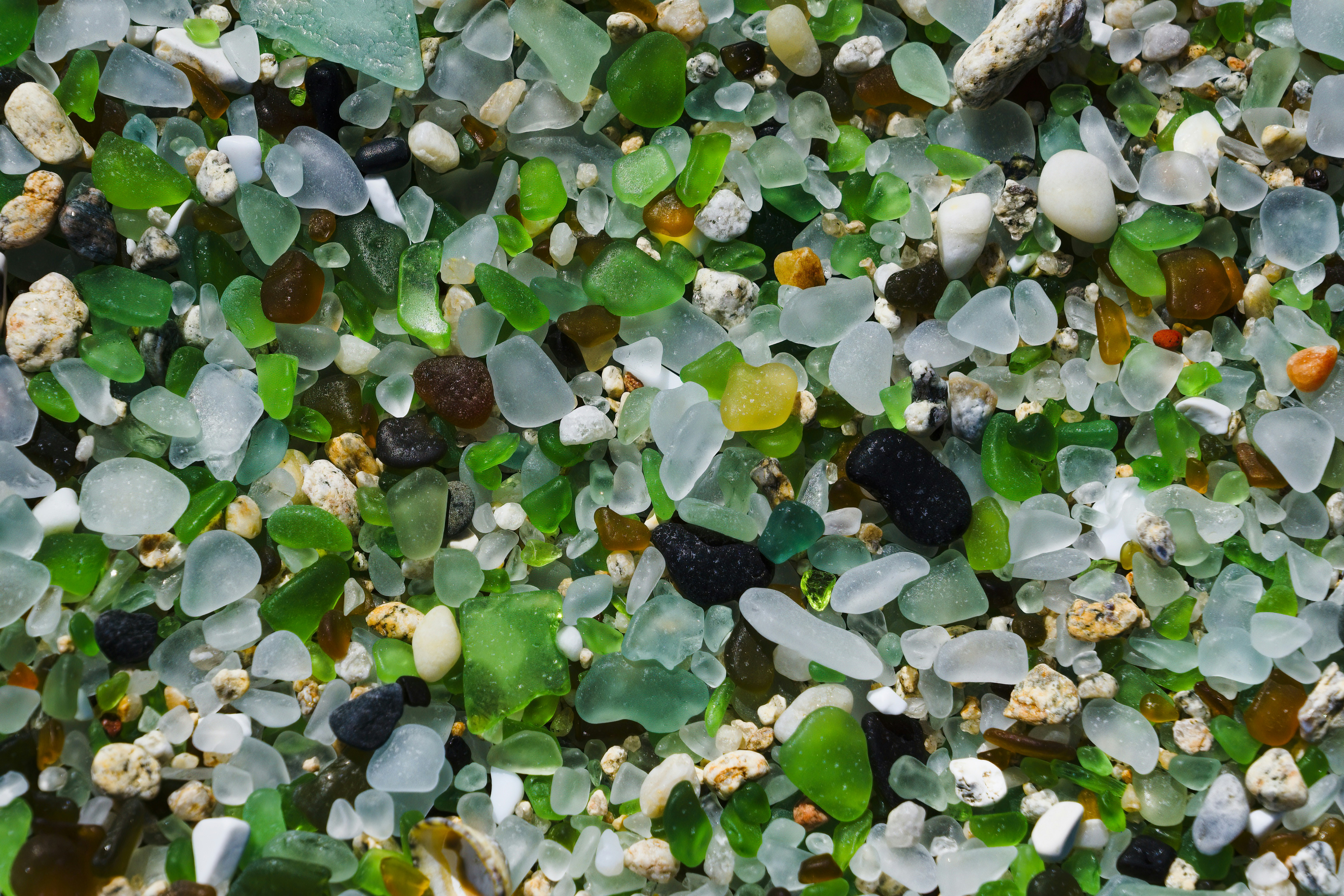 A mixture of sea glass on a beach
